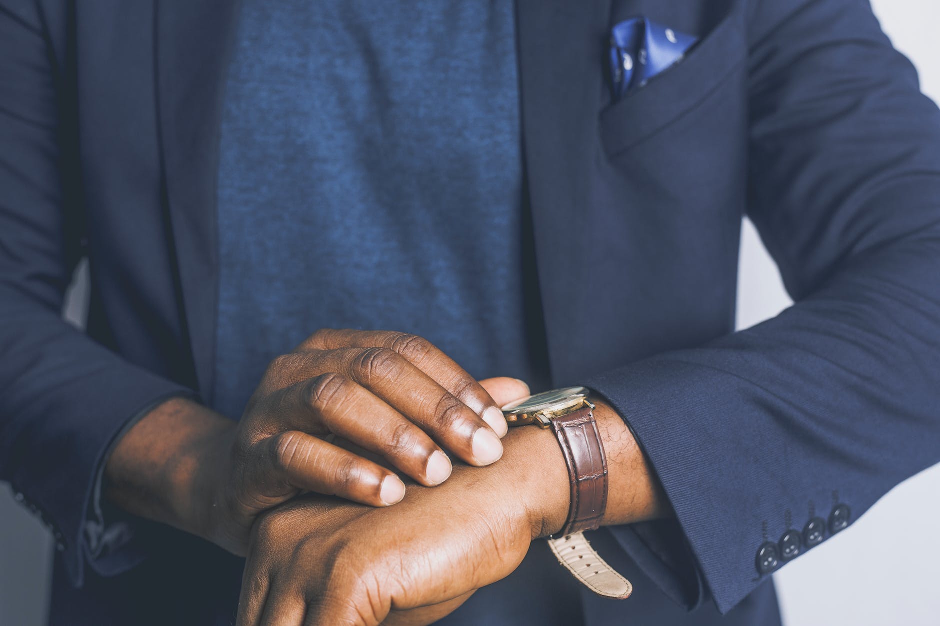 standing man looking his watch