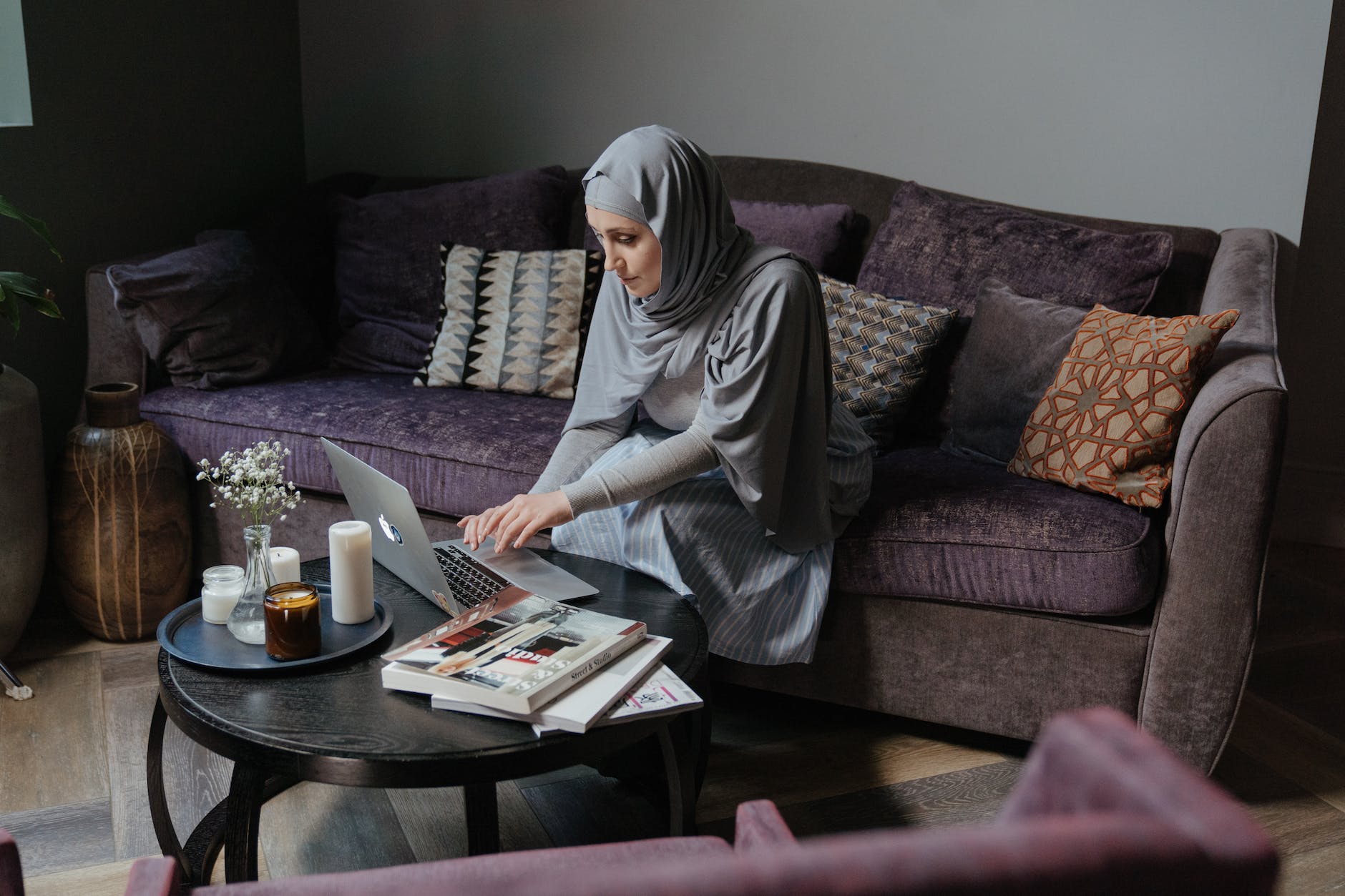 woman in gray hijab sitting on couch