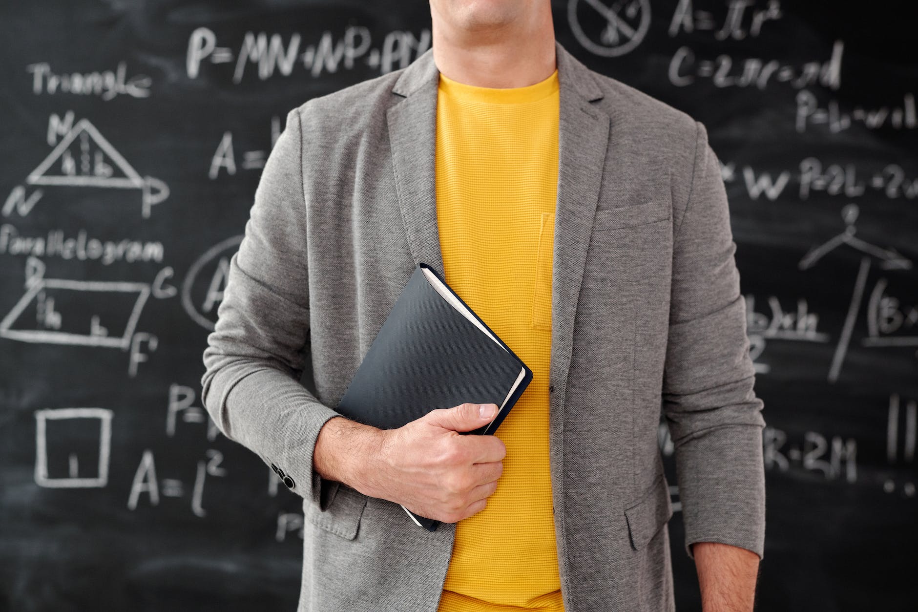 unrecognizable person holding a notebook