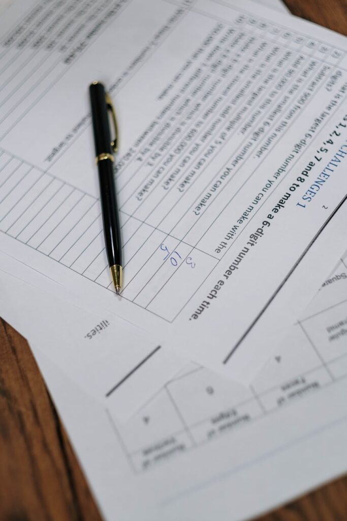 photograph of a black pen on top of a white paper